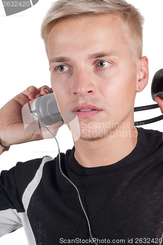 Image of Male taking off headphones