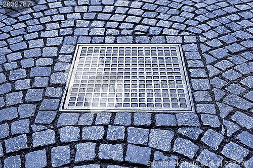 Image of Paving stones with metal manhole