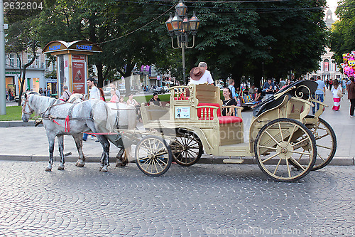 Image of coach with two harnessed horses in Lvov