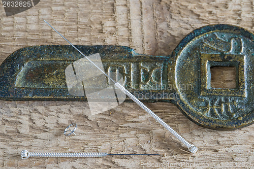 Image of Acupuncture needles with antique chinese coin