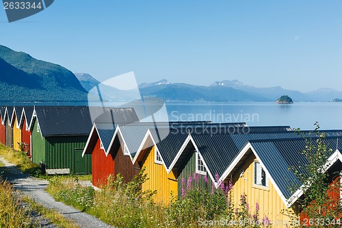 Image of Colorful camping cabins on the fjord shore