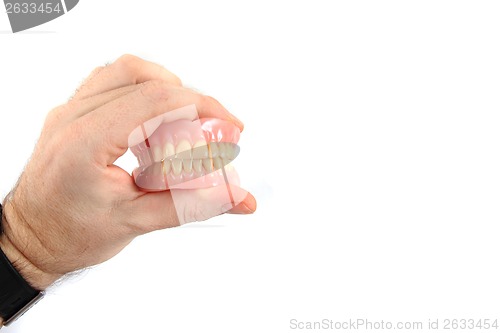 Image of teeth prosthesis in human hand