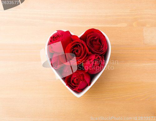 Image of Rose in red inside heart shape bowl