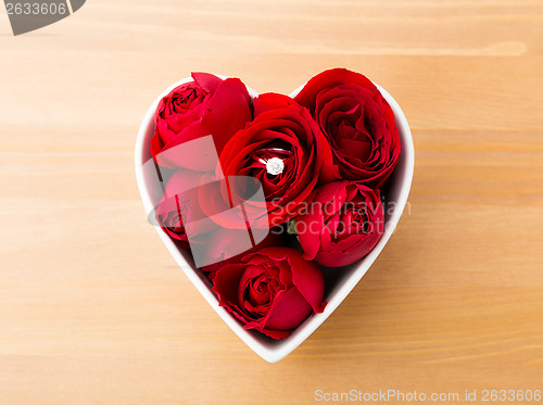 Image of Rose with diamond ring inside the heart shape bowl