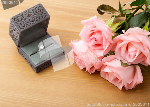 Image of Engagement ring and pink rose 