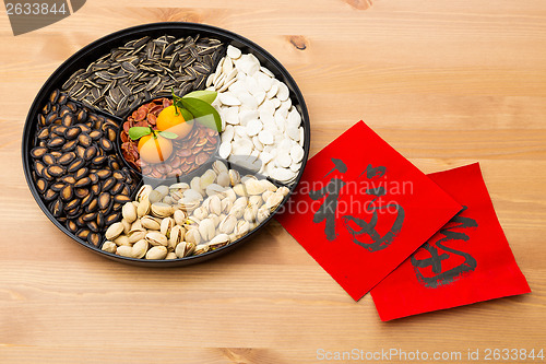 Image of Traditional Lunar new year snack tray and chinese calligraphy, m