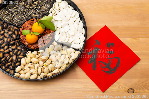 Image of Traditional Lunar new year snack tray and chinese calligraphy, m