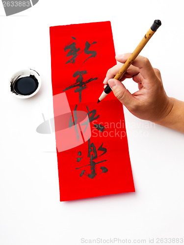 Image of Writing of chinese new year calligraphy, phrase meaning is happy