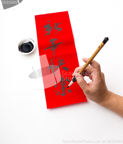 Image of Writing of chinese new year calligraphy, phrase meaning is happy