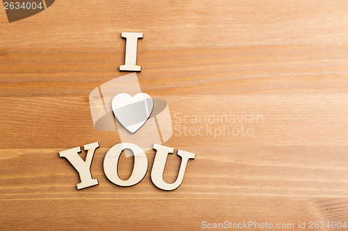 Image of Wooden letters forming with phrase I Love You and over the woode