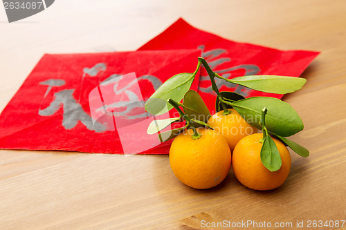 Image of Chinese new year calligraphy and kumquat, word meaning is good l