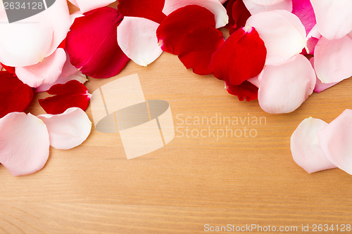 Image of Rose petal with wooden background