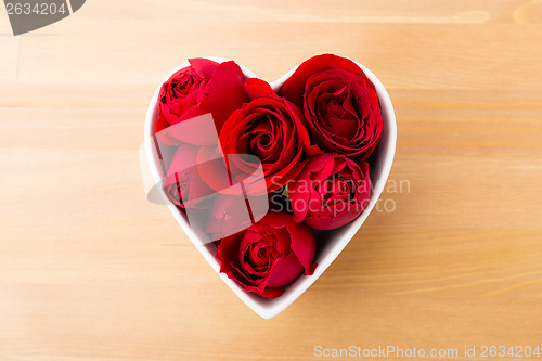 Image of Red rose inside the heart shape bowl 