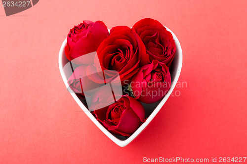 Image of Red rose inside the heart shape bowl