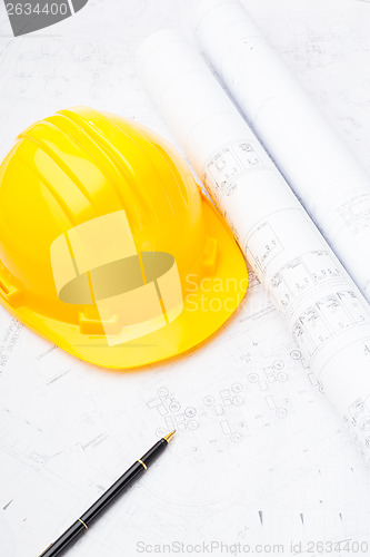 Image of Construction drawing and safety helmet