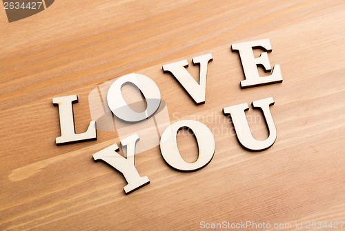 Image of Wooden texture letters forming with phrase Love You 