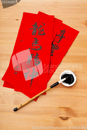 Image of Writing of Chinese new year calligraphy, phrase meaning is bless