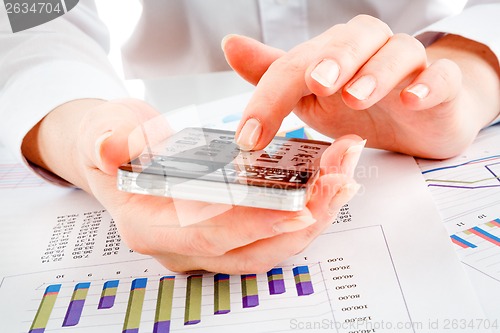 Image of Smartphone with transparent screen in human hands.