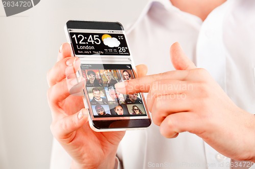 Image of Smartphone with transparent screen in human hands.