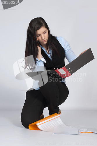 Image of Young woman is squatting and phone