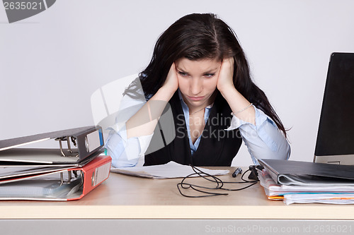 Image of Young female office worker at desk