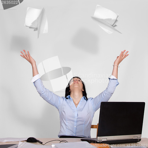 Image of Woman throws out paper into the air