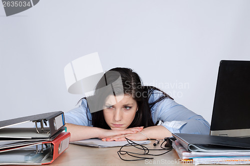 Image of Young female office worker at desk