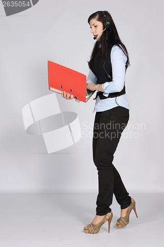 Image of Young woman with a headset and documents