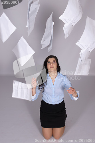 Image of Woman throws out paper into the air