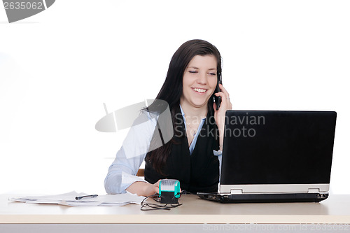 Image of Young woman behind a desk phone