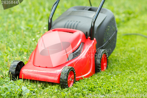 Image of new lawnmower on green grass