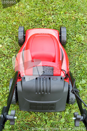 Image of new lawnmower on green grass