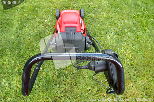 Image of new lawnmower on green grass