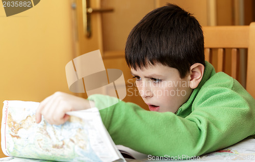 Image of bored and tired boy doing homework