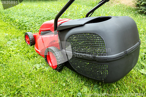 Image of new lawnmower on green grass