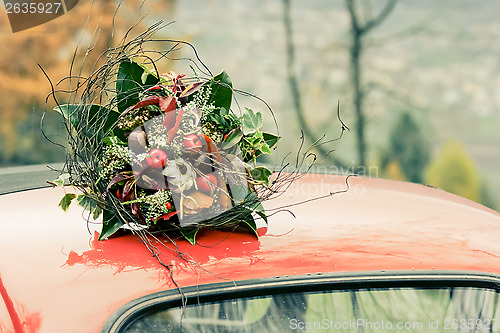 Image of Autumnal bouquet on the top of retro car