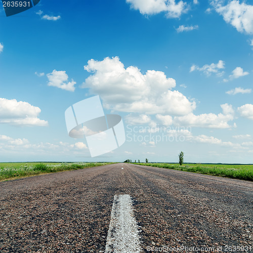 Image of asphalt road close up under clouds in blue sky