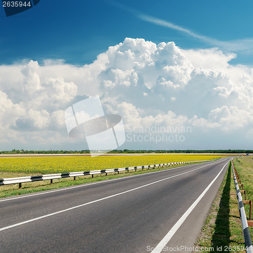 Image of asphalt road goes to cloudy horizon
