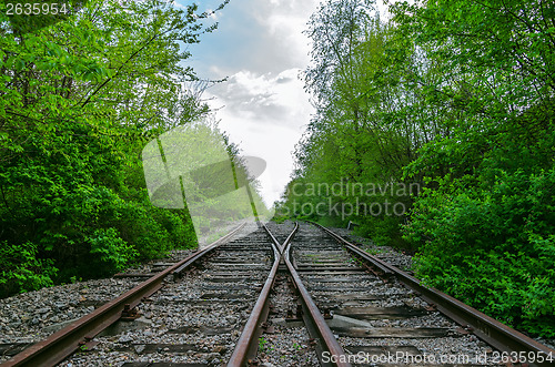 Image of crossing of two railroads in wood
