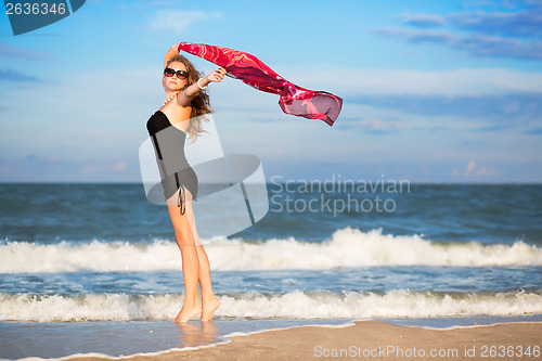 Image of Pretty slim woman with pink pareo