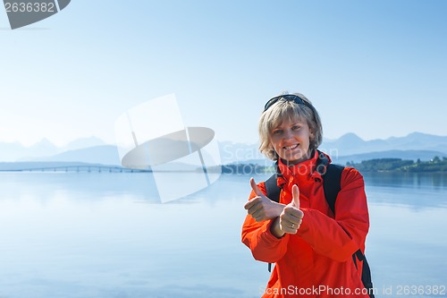 Image of Woman tourist showing thumbs up