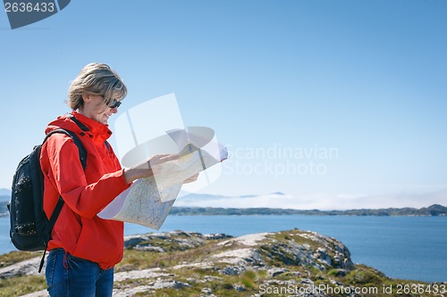 Image of Woman tourist reading the map