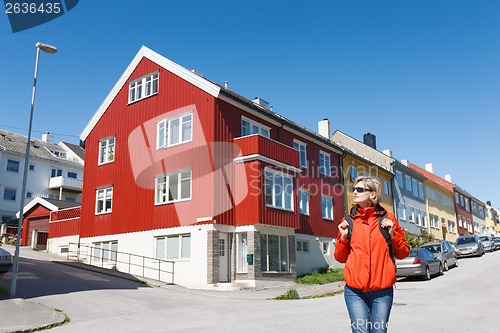 Image of Tourist standing against multicolored houses