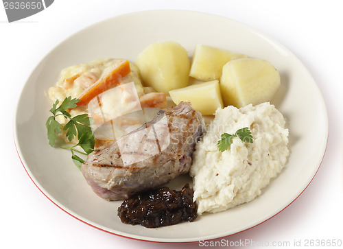 Image of Veal steak with gourmet vegetables side view