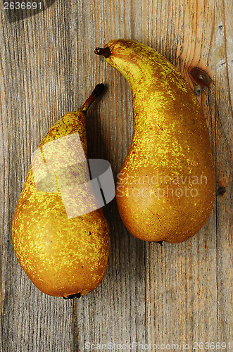 Image of two fresh pears on a wooden background