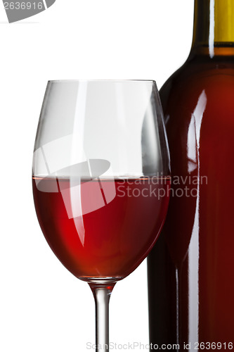 Image of Glass of red wine and bottle on stump isolated on white