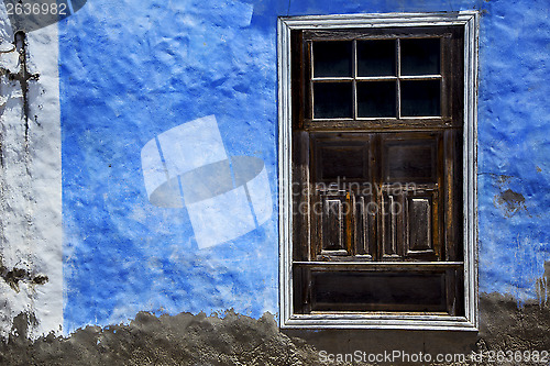 Image of  brown wood   window in a blue wall arrecife lanzarote 