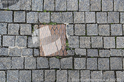 Image of Paving stones background with metal plate