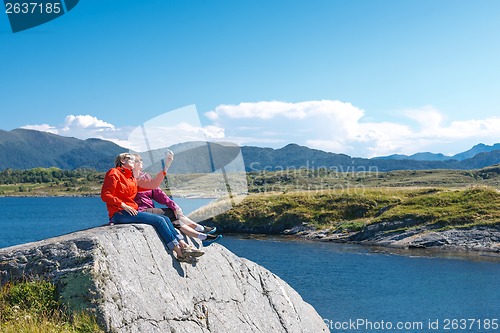 Image of Two women tourists taking photo of themselves