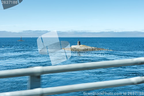 Image of Lighthouse on the rock looking like submarine.